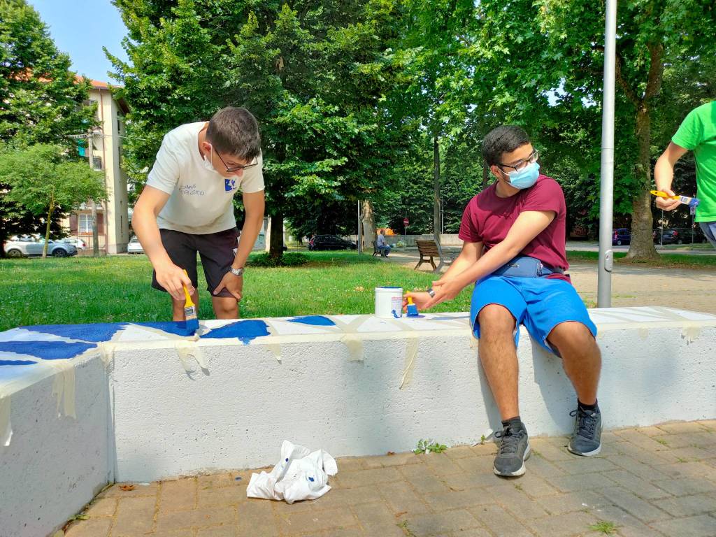 Giovani saronnesi al lavoro per dipingere le panchine del Matteotti 